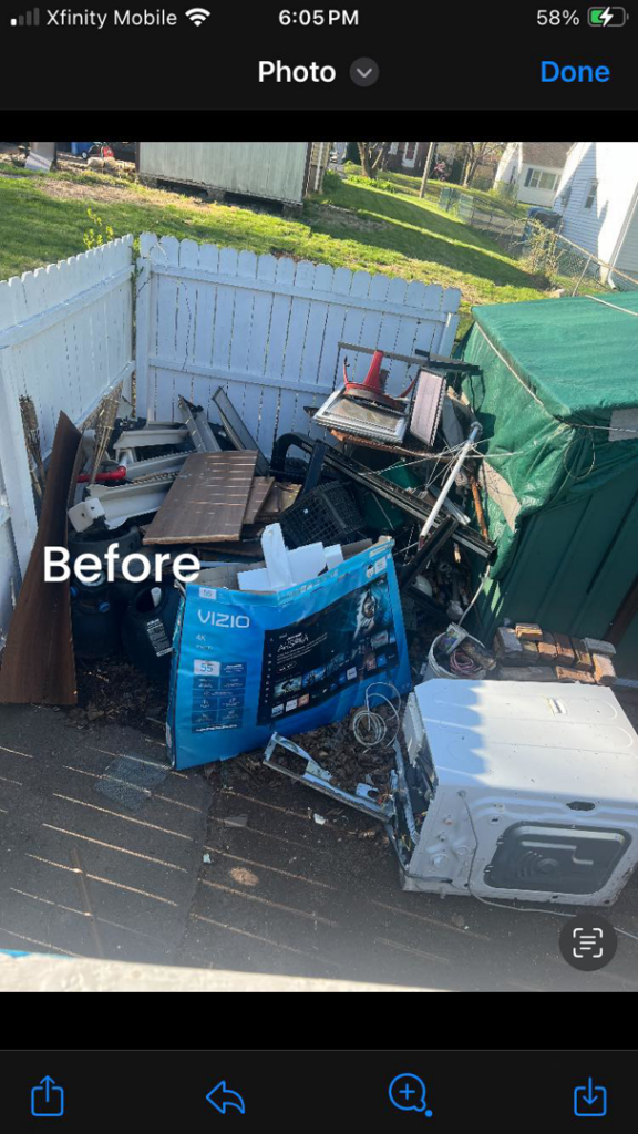 A 'before' photo showing a large pile of household junk in a backyard, ready for Happy Hauling & Junk Removal in Hartford, CT.