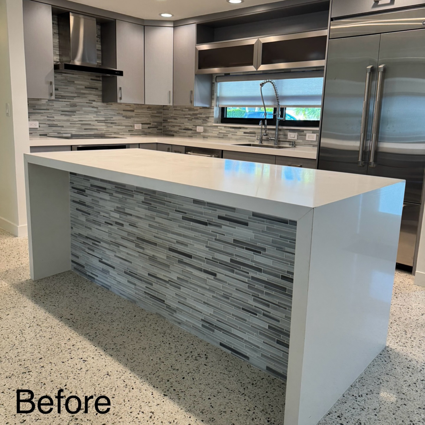 A "before" view of a kitchen island with existing tile, prior to renovation by Broward Tile Guys in Pompano Beach, FL.