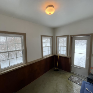 An 'before' view of a room needing renovation, showing a dirty floor and an old light fixture by A 2 Z Home Services - Fairmont WV.
