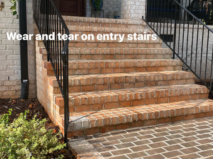Before photo showing wear and tear on brick entry stairs, ready for restoration by East Coast Brick Staining in Raleigh, NC.