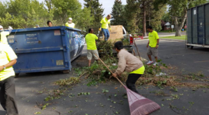A green garbage truck with 'Benjamin's Rural Disposal' logo parked, representing junk removal services in Meridian, ID.