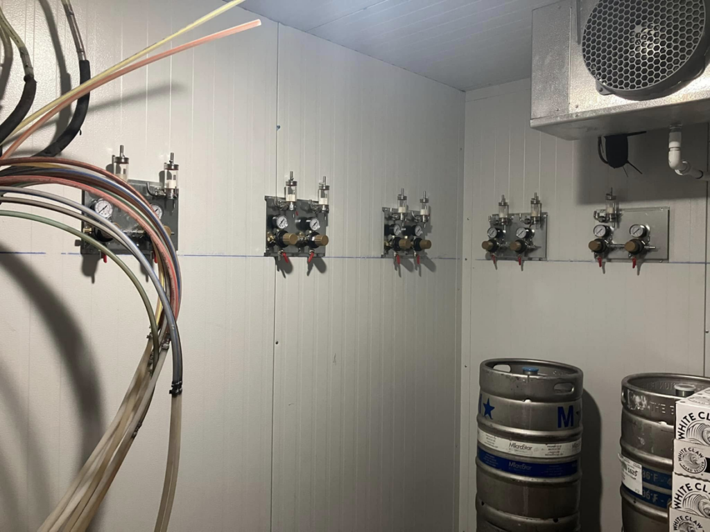 Gas regulators and lines for a beverage system professionally installed in a walk-in cooler by Black Tide Beverage in Lakewood, CO.