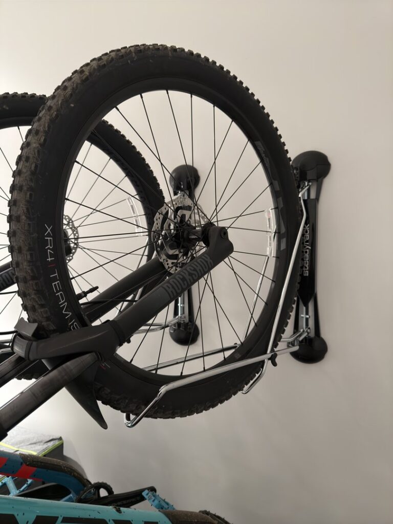 A bicycle securely mounted on a wall rack, installed by I Know A Guy Handyman Service in Cottage Grove, MN.