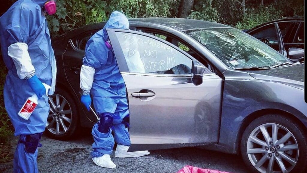 Biohazard PRO specialists in protective gear performing car cleanup and junk removal in Boston, MA.