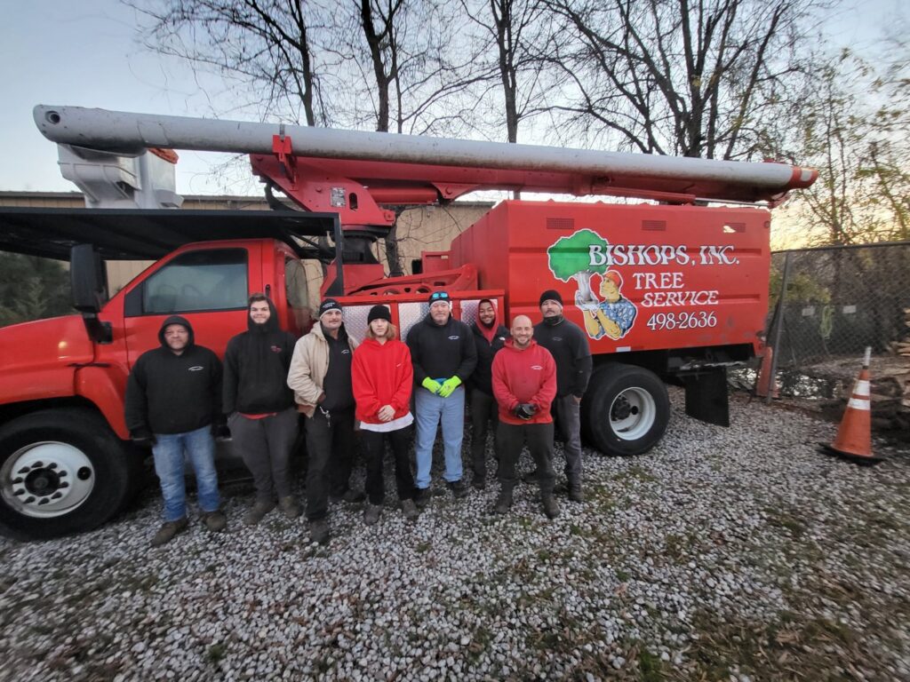 The dedicated team of Bishops Tree Service Inc. standing with their bucket truck in Virginia Beach, VA.