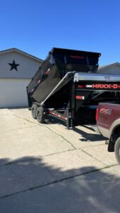 A black dumpster being emptied by a truck from Waste-Away Dumpsters & Disposal LLC, demonstrating disposal services in Sioux Falls, SD.