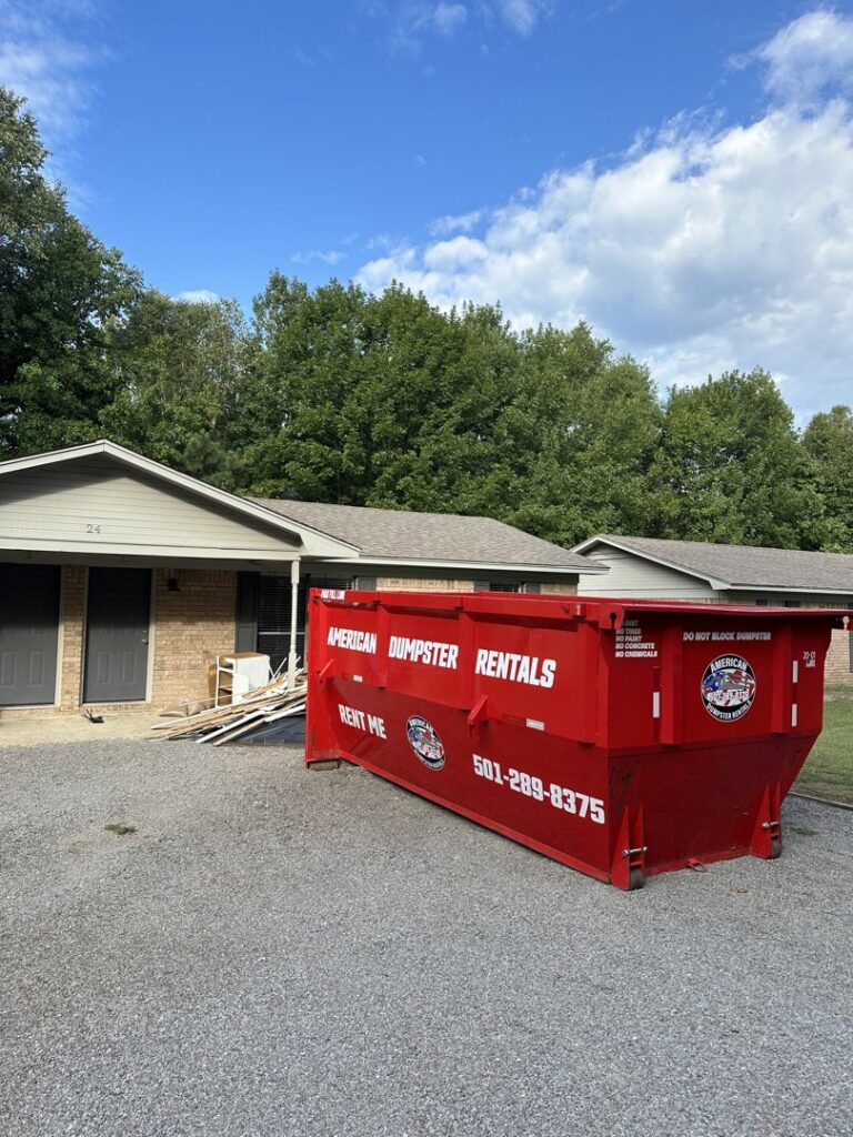 A black dumpster from American Dumpster Rentals placed on a residential street or driveway in Morrilton, AR.