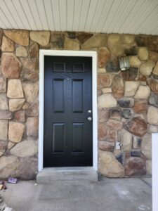 A newly painted black front door, a service provided by Joe's Handyman Solutions in Ogden, UT.