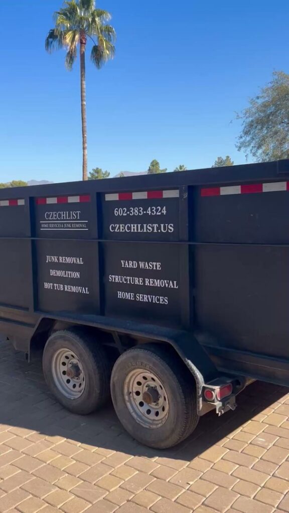 A black junk removal trailer with CzechList Junk Removal branding, ready for service in Scottsdale, AZ.