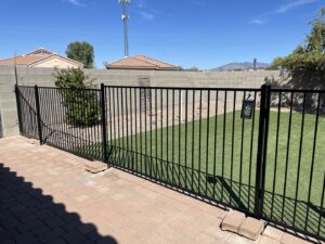 A black metal backyard fence and gate installed by Affordable Fence & Gates in Tucson, AZ.