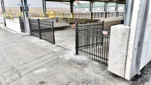 Black metal security fencing and gates installed around a commercial loading dock by Aaron Fence in Tulsa, OK.