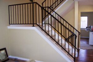 Black metal interior staircase railings installed by Xclusive Fence And Rails Inc. in Miami, FL.