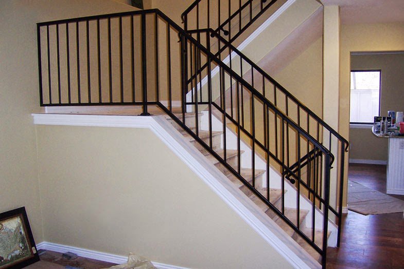 Black metal interior staircase railings installed by Xclusive Fence And Rails Inc. in Miami, FL.