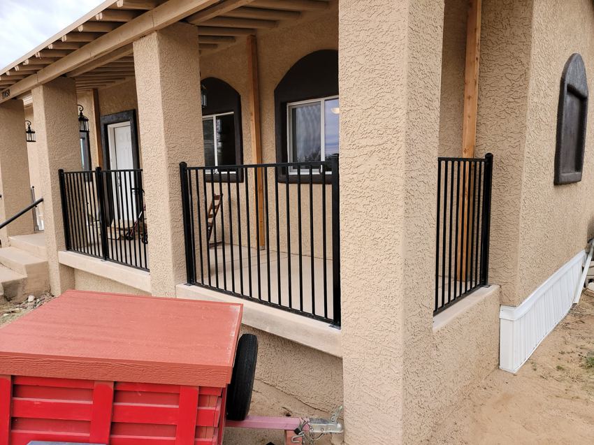 Professional installation of a black metal porch railing by Able Fence LLC in Tucson, AZ.
