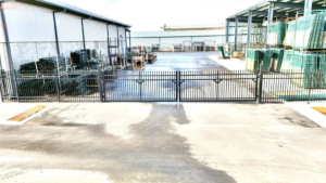 A robust black metal security fence and gate installed at a commercial property by Aaron Fence in Tulsa, OK.