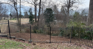 A black ornamental metal fence installed in a residential backyard by Tim's Fencing in Knoxville, TN.