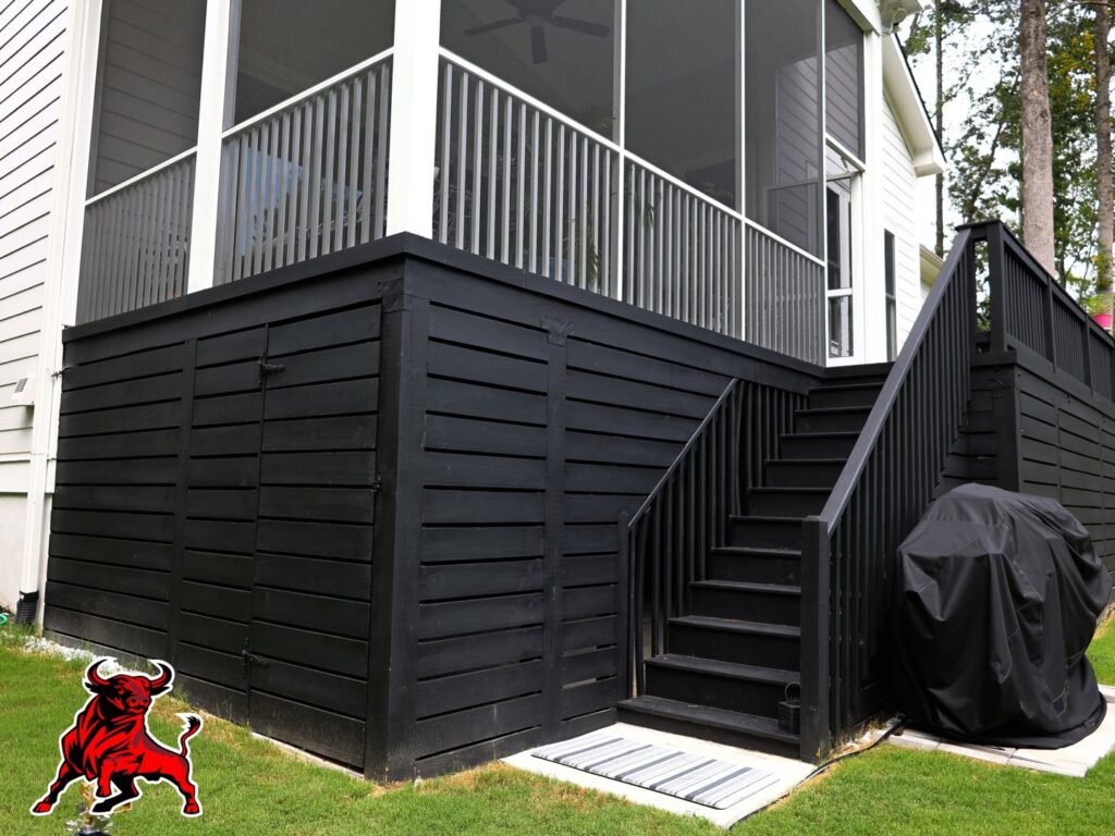 A newly painted black deck and stairs with integrated storage by Bull City Painting & Roofing in Durham, NC