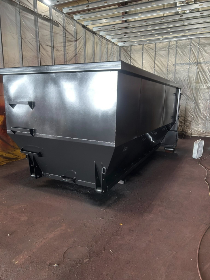 A black roll-off container for large-scale junk removal from Eagle Industrial Solutions in Louisville, KY.