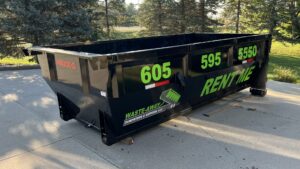 A black roll-off dumpster from Waste-Away Dumpsters & Disposal LLC in a residential driveway in Sioux Falls, SD.
