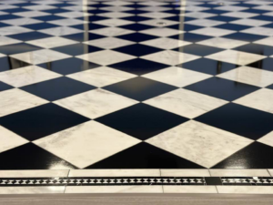 Close-up of a newly installed black and white checkered floor by Eminent Renovations in Phoenix, AZ.