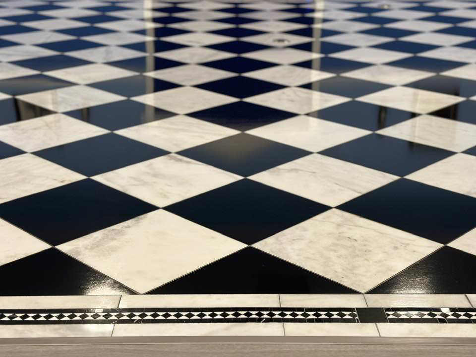 Close-up of a newly installed black and white checkered floor by Eminent Renovations in Phoenix, AZ.