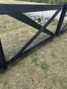 A newly installed black wooden fence with wire mesh, a service provided by Fence&Wash in Rock Hill, SC.