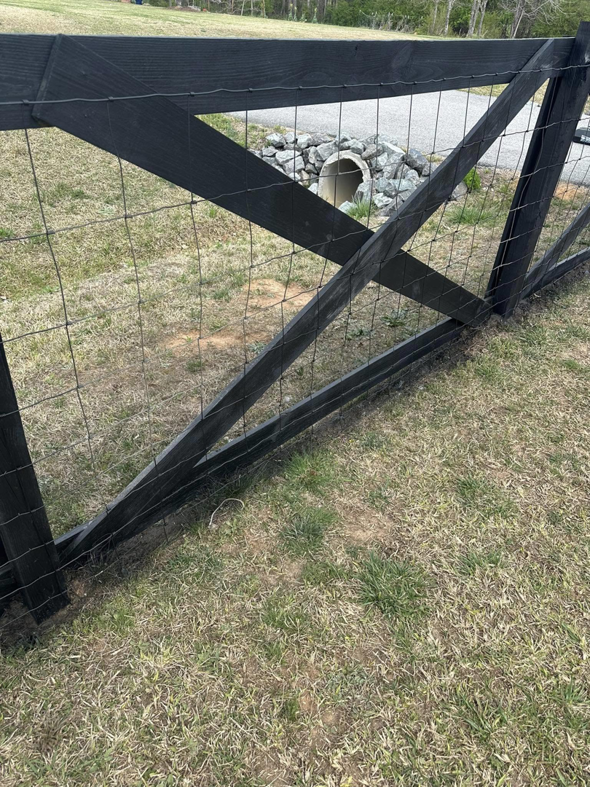 A newly installed black wooden fence with wire mesh, a service provided by Fence&Wash in Rock Hill, SC.