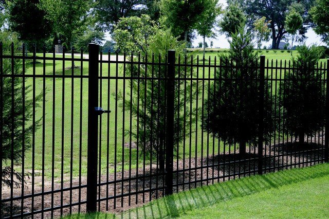 A sleek black wrought iron style fence with a secure gate, installed by Fence Factory Inc in Stamford, CT