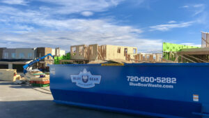A Blue Bear Waste Services dumpster on a construction site for debris removal in Denver, CO.