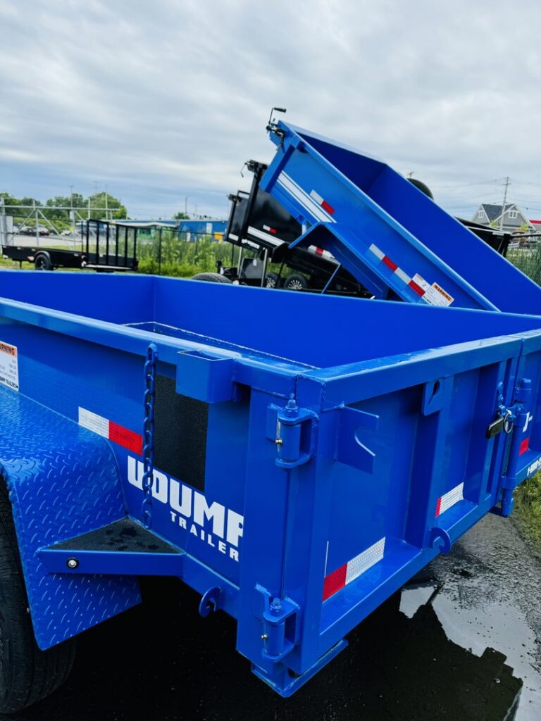 A bright blue dump trailer, ideal for hauling materials, available from Handyman Vehicle Outfitters in Portland, ME.