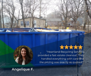 A blue dumpster filled with various junk and debris from an estate cleanout by Heartland Recycling Services in Portland, OR.