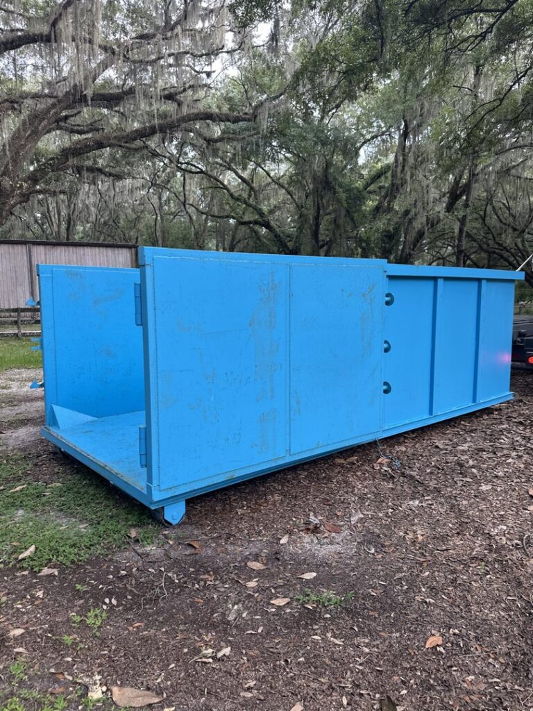 A blue dumpster from Big Skye Dumpsters with its back door open, ready for junk removal in Jacksonville, FL.