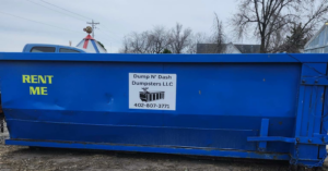 A large blue dumpster with a "RENT ME" sign from Dump N Dash Dumpsters LLC, ready for junk removal in Valley, NE.