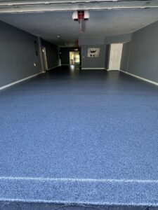 A vibrant blue flake epoxy garage floor expertly installed by Floor Coating Specialist in St. Petersburg, FL.