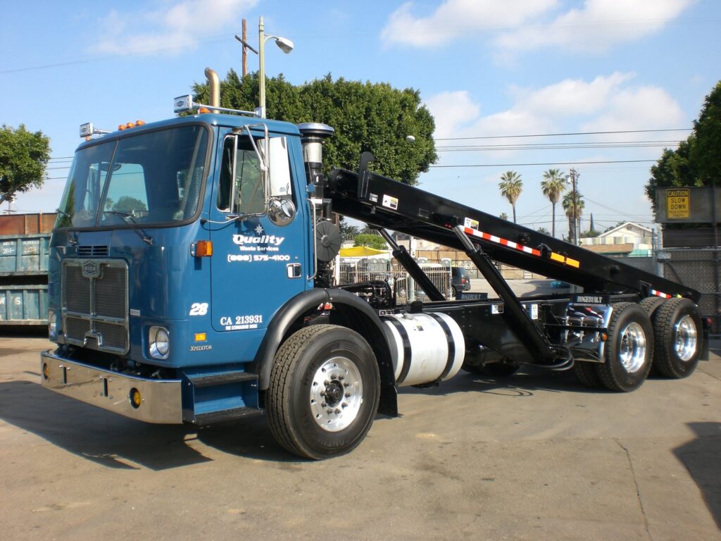 A blue garbage truck used for junk removal by Quality Waste Service, Inc. in Los Angeles, CA.