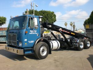 A blue garbage truck used for junk removal by Quality Waste Service, Inc. in Los Angeles, CA.