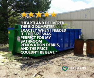 A blue and green dumpster used for bathroom renovation debris by Heartland Recycling Services in Portland, OR.