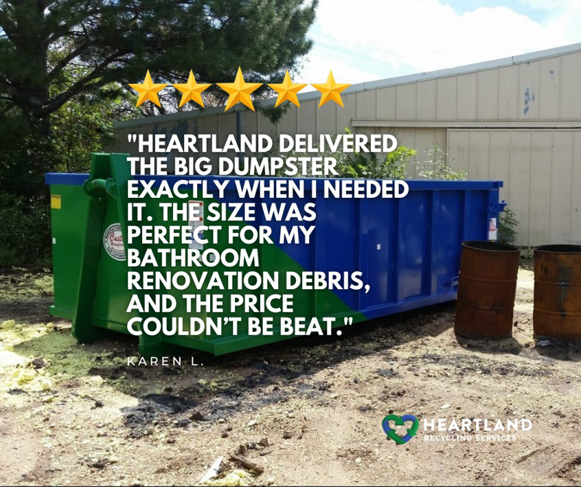 A blue and green dumpster used for bathroom renovation debris by Heartland Recycling Services in Portland, OR.