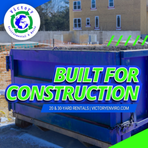 A blue roll-off dumpster positioned at a construction site by Victory Environmental and Waste in High Point, NC.