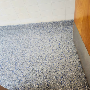 A completed blue-speckled epoxy floor installation by Lifetime Epoxy Floors North Alabama in Boaz, AL.