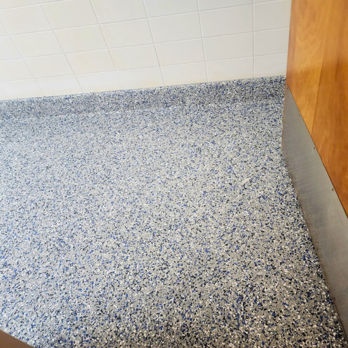 A completed blue-speckled epoxy floor installation by Lifetime Epoxy Floors North Alabama in Boaz, AL.