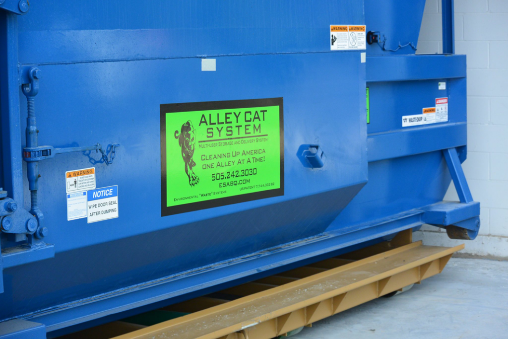 A large blue waste compactor provided by Environmental Systems/Bravo Sales Rentals for junk removal in Albuquerque, NM.