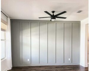 A room featuring custom board and batten wall paneling and a newly installed ceiling fan by Renegade Woodworks in Kearney, NE.