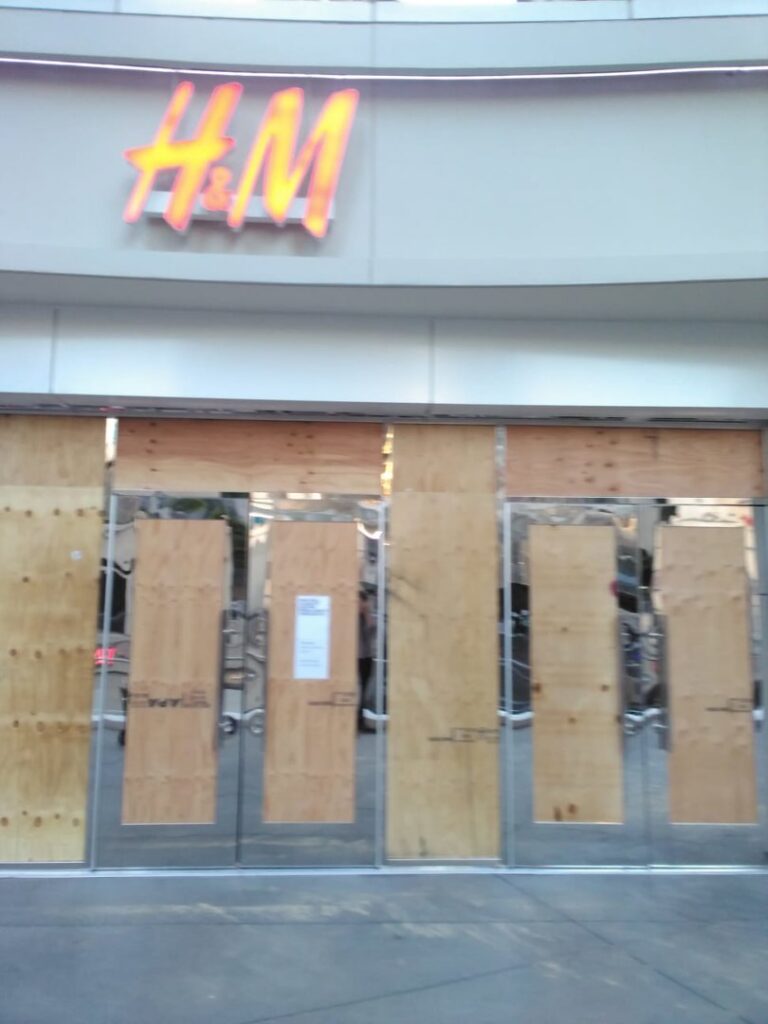 A commercial storefront boarded up with plywood for security or repair by DemoCraft Commercial Services in Everett, WA