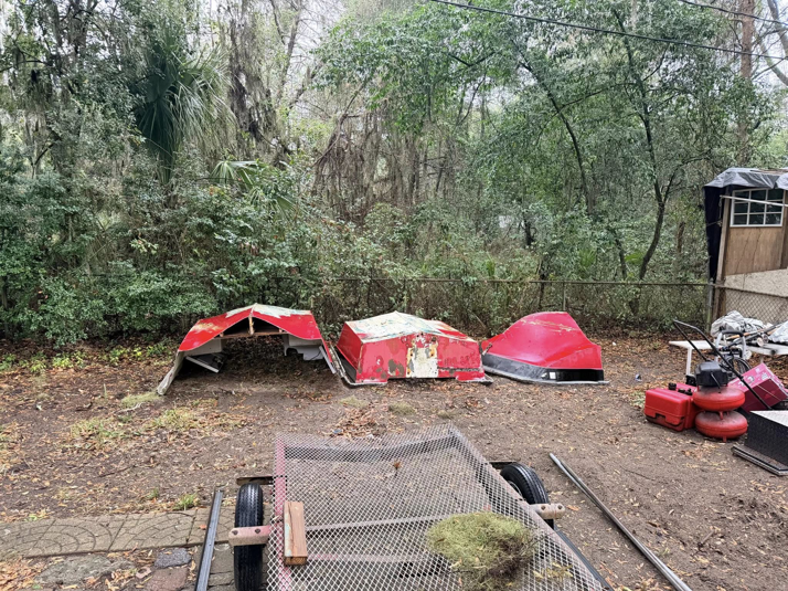 Several pieces of boat debris scattered in a yard, ready for junk removal by Won't Bash Your Trash in Savannah, GA.