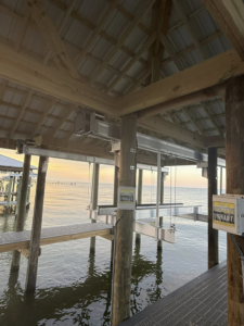 Boat lift electrical control boxes and mechanisms installed on a covered dock by Payne's Marine Service, LLC in Fairhope, AL