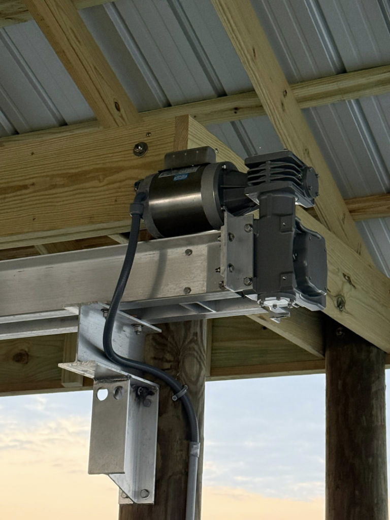 Close-up of a boat lift motor and pulley system installed by Payne's Marine Service, LLC in Fairhope, AL