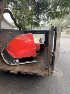 Broken boat parts loaded into a junk removal trailer by Won't Bash Your Trash in Savannah, GA.