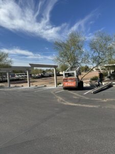 A Bobcat skid steer clearing debris in a parking lot, demonstrating site cleanup services by HAVOC Demolition in Scottsdale, AZ.