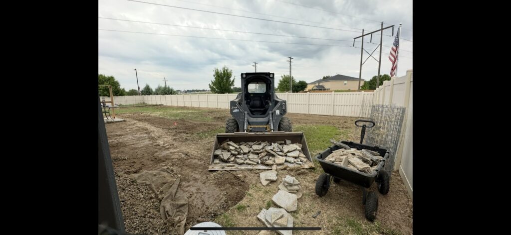A bobcat loading broken concrete and pavers for a junk removal job by Haul My Load LLC in Caldwell, ID.